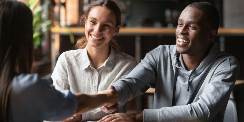 Happy,Young,Interracial,Couple,Shake,Hand,Of,Bank,Manager,Broker